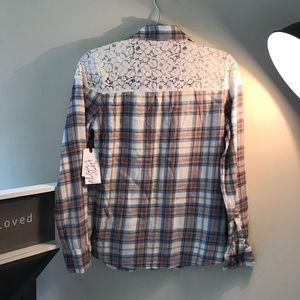 Plaid shirt with lace on shoulders.